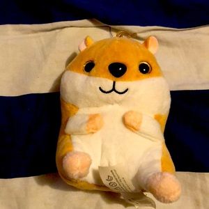 A tiny stuffed animal hamster